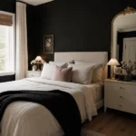 Chic black bedroom with a matte black accent wall and soft cream bedding