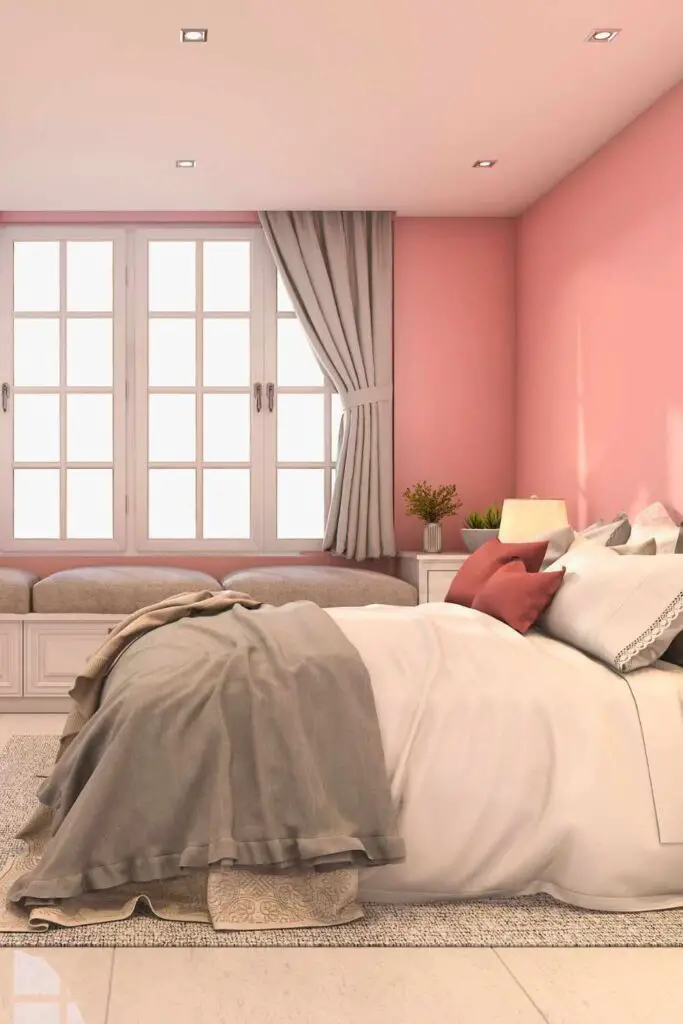 Pink walls with grey curtains and blankets